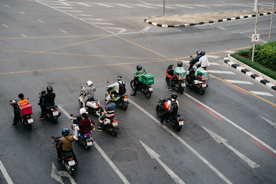Aerial view of motorcyclists at an intersection in a city.